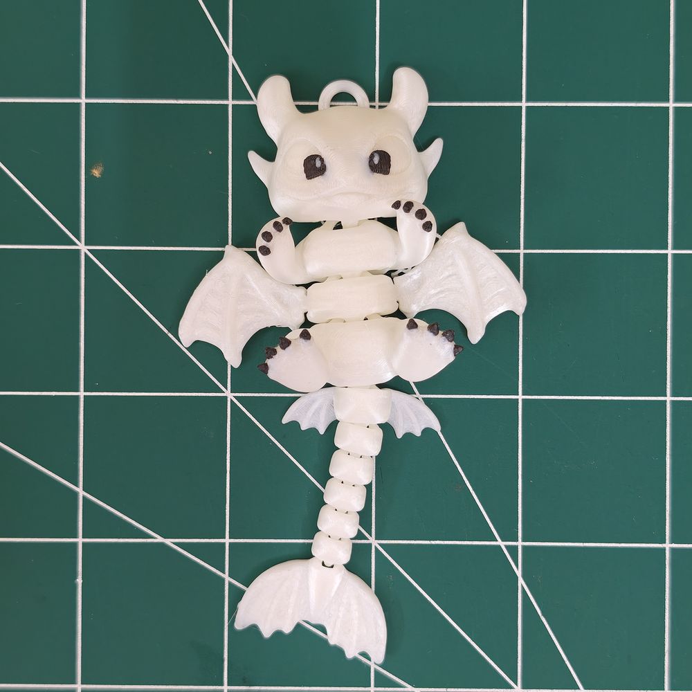 A white articulated dragon with print-in-place joints