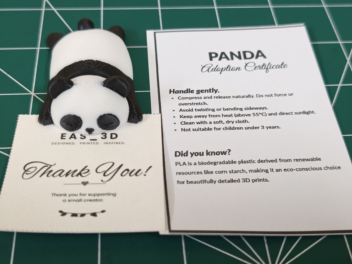 A Slinky Panda beside its printed adoption certificate